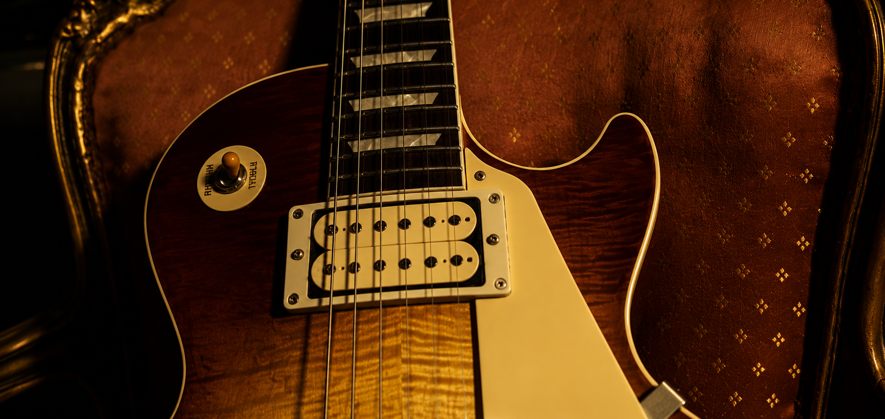 A handwound humbucker resting under warm workshop light